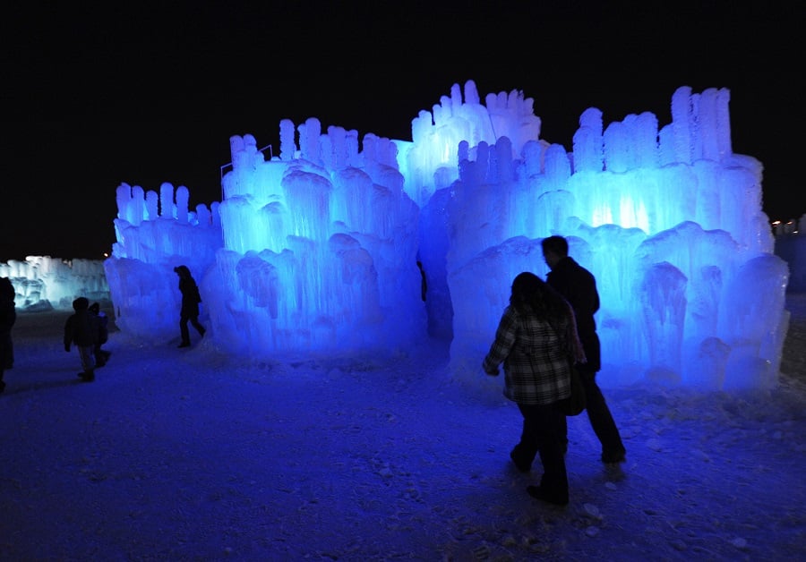 Visitors explore the Mall of America Ice Castle Friday, Jan. 4, 2013 in Bloomington, Minn. The castle is made of icicles organically grown from four million gallons of water and then fused together. (AP Photo/Jim Mone)
