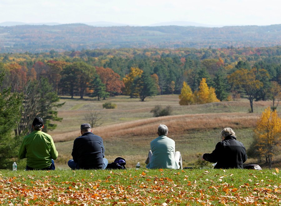elderly people sitting on a hill